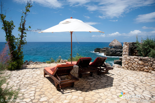 Some lounge chairs along the cliffs at Tensing Pen in Negril, Jamaica