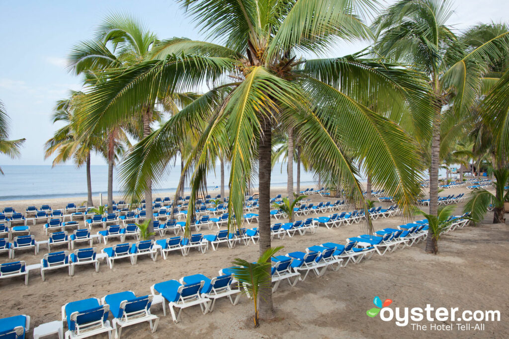 Beach chairs and palm trees at Riu Palace Pacifico All Inclusive in Riviera Nayarit