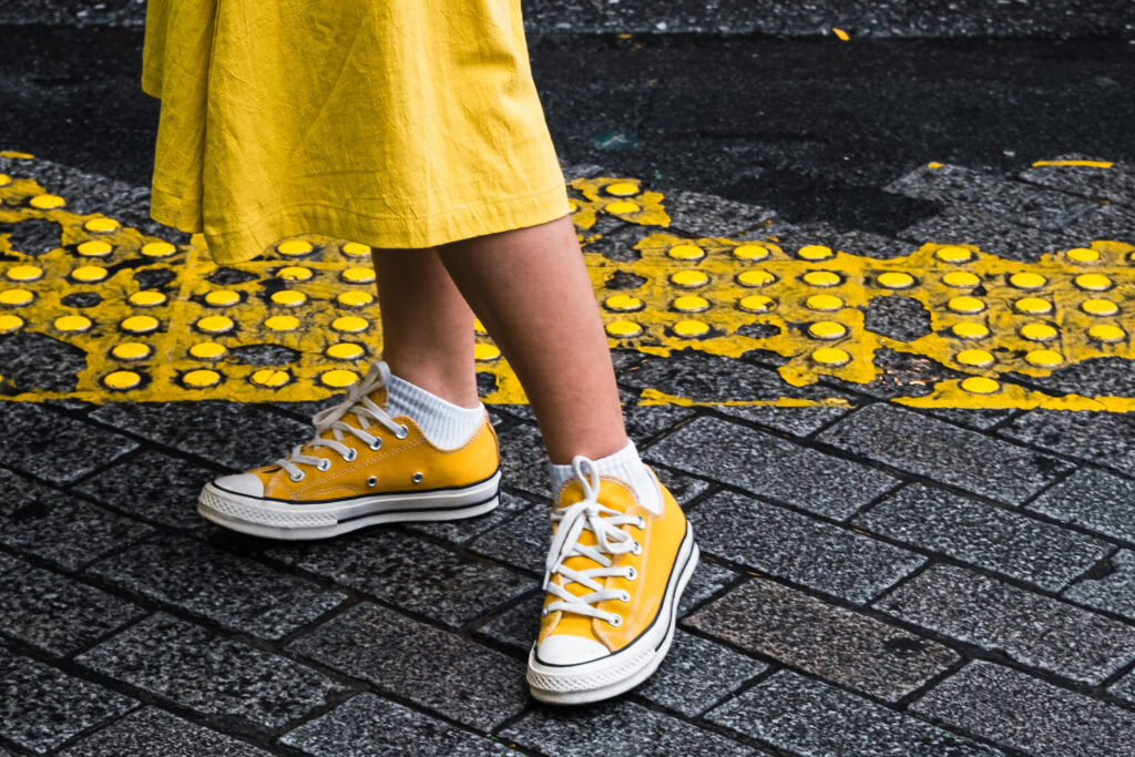 Yellow Converse on a woman