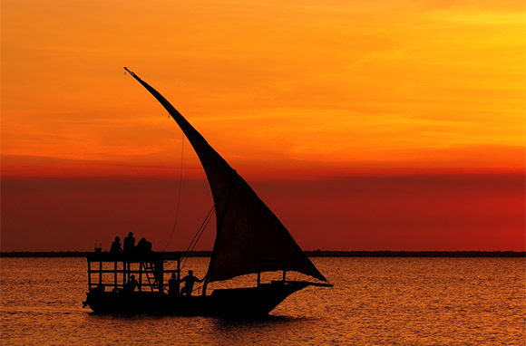Photo Credit: Dhow Boat at Sunset via Shutterstock