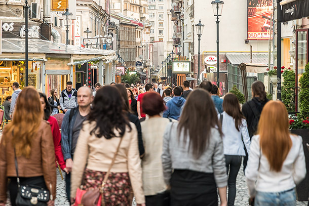 Photo: Tourists Visting And Having Lunch At Outdoor Restaurant via Radu Bercan/Shutterstock.com