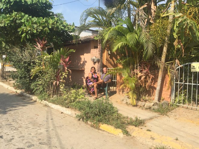 Keith and his landlord, Paula. "When Paula sits outside with me, every passerby in a car or across the street eating tacos gives an “Ay! Buenos dias!  Que Pasa? Adios!” Well, it’s usually first directed to Paula, but after I respond with a smile and some Spanish, I get a grin, eyebrow raise, and a warm, approving response," he says.