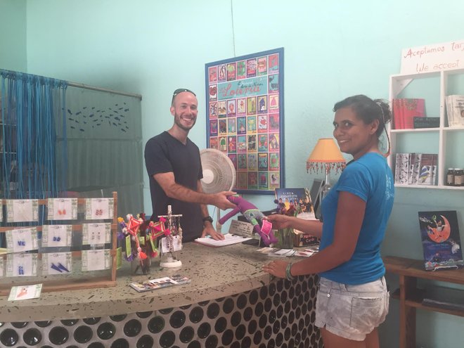 Keith manning the "Galeria" desk at Entre Amigos, a community center where he volunteers.