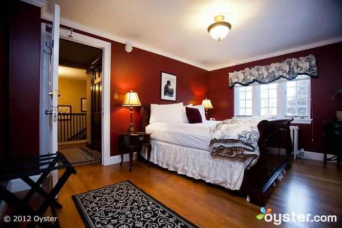 The Ripley Suite has a warm, classic vibe with burgundy walls and French Country curtains.