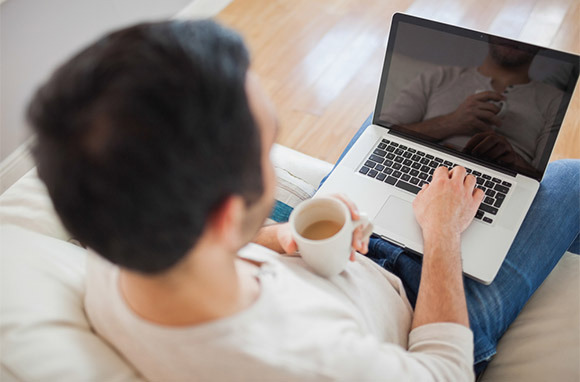 Man Using Laptop via Shutterstock
