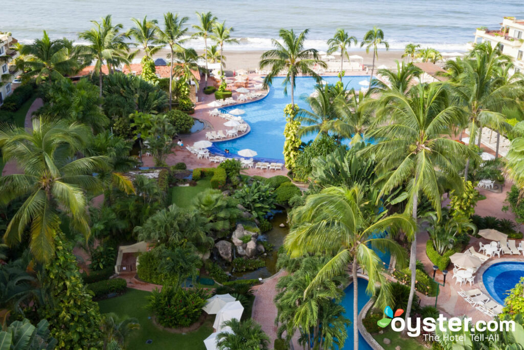 The pool and beach with palm trees at Velas Vallarta