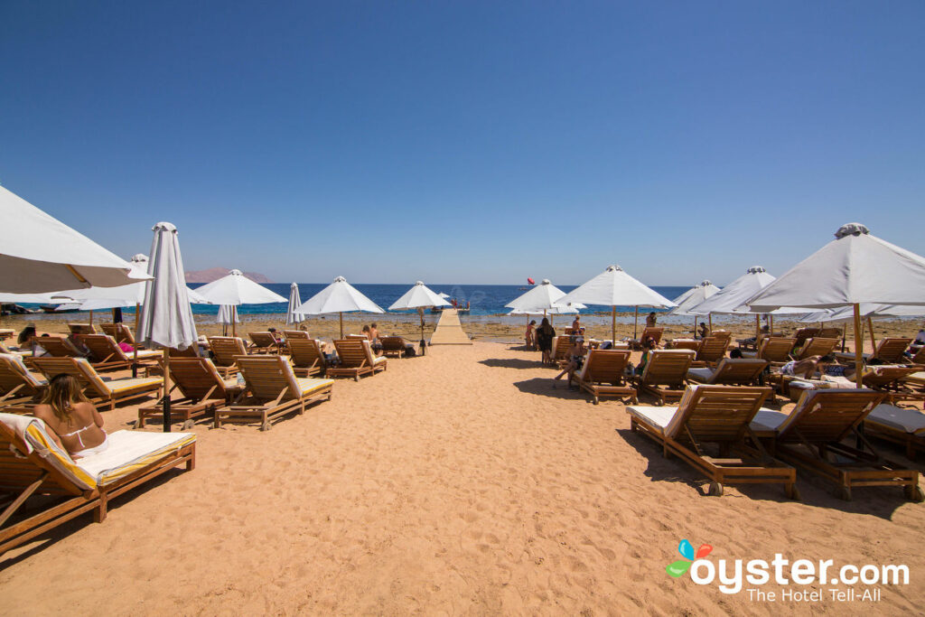 Loungers dot the sand.