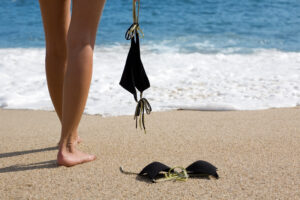 Woman standing on beach with bikini