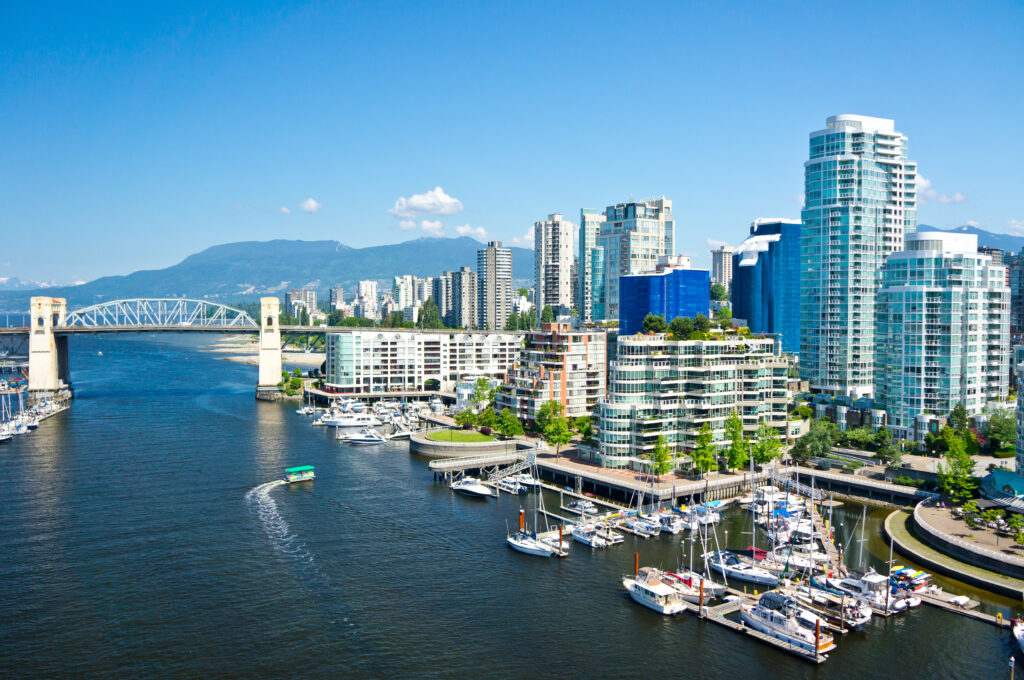 Skyline of Vancouver, British Columbia next to a river on a clear day
