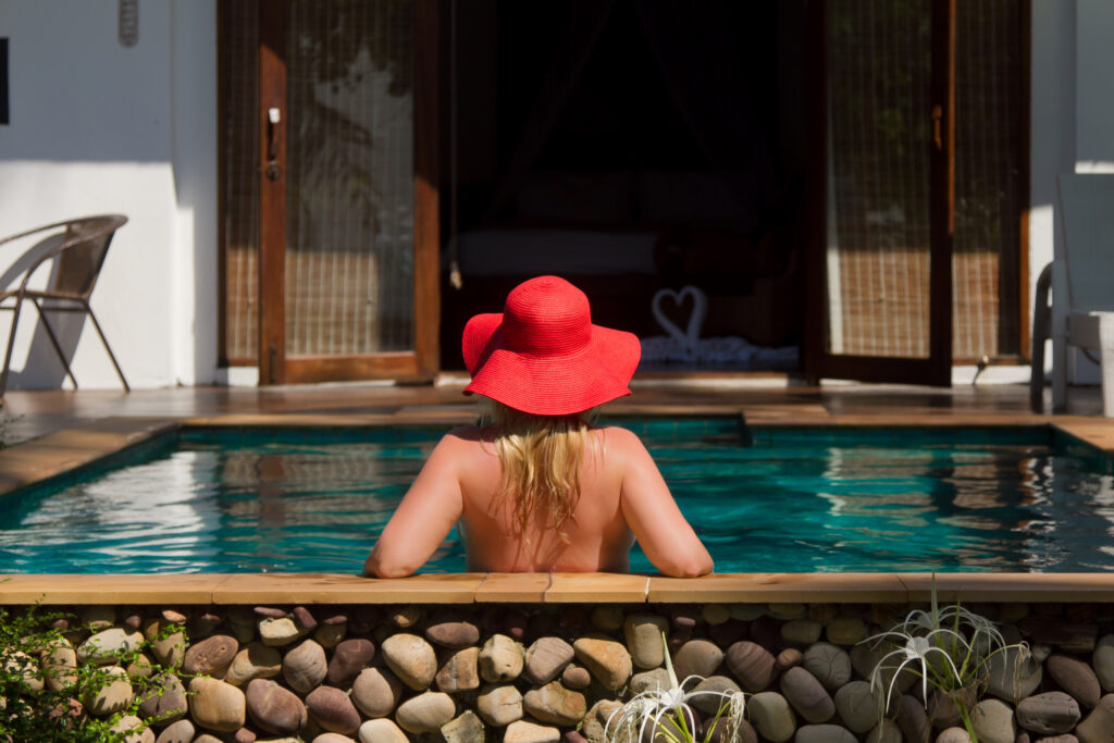 Woman relaxing in an open air pool outside of hotel room