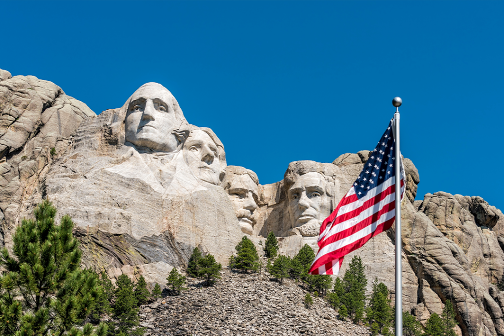 American flag waiving in front of Mount Rushmore