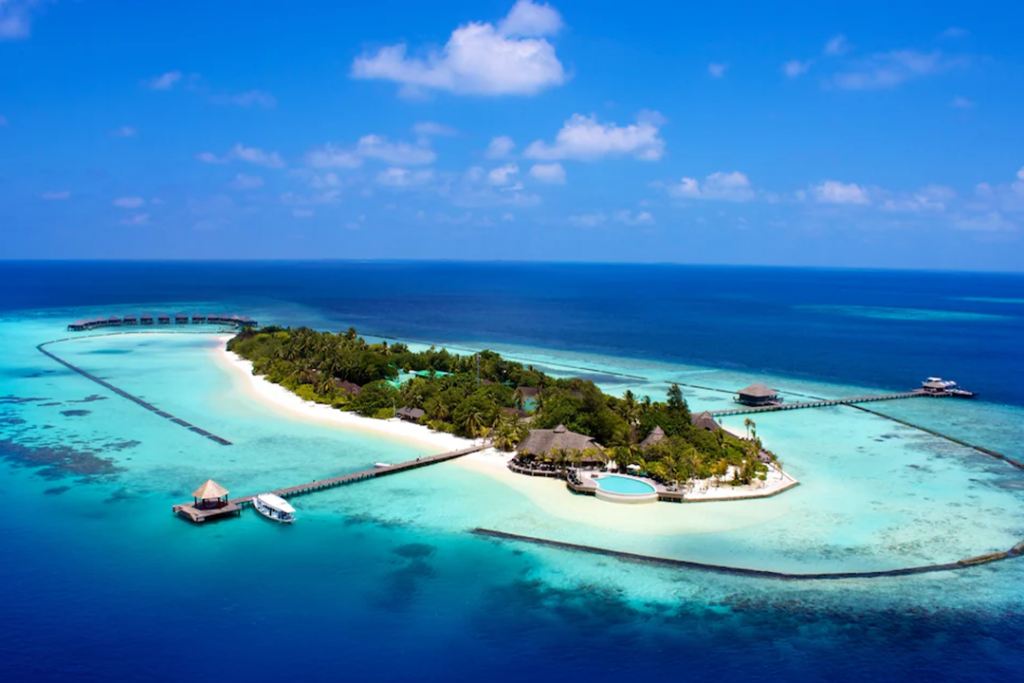 Aerial view of the island where Komandoo Maldives Island Resort is located