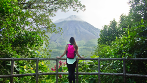 Female hiker looking out at the Arenal volcano in Costa Rica