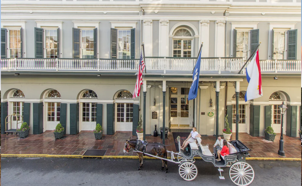 Front of the Bourbon Orleans Hotel with horse and carriage outside.