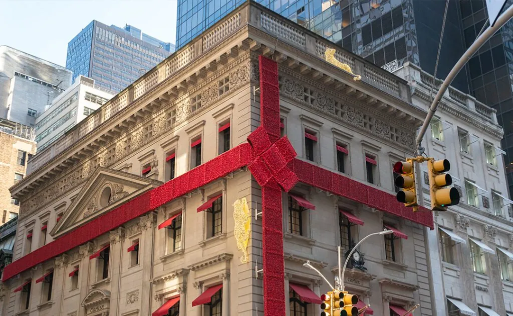 New York City, New York - December 2019: 2019 installation of the Cartier flagship store on Fifth Avenue with the gigantic bow and jaguars climbing the sides.