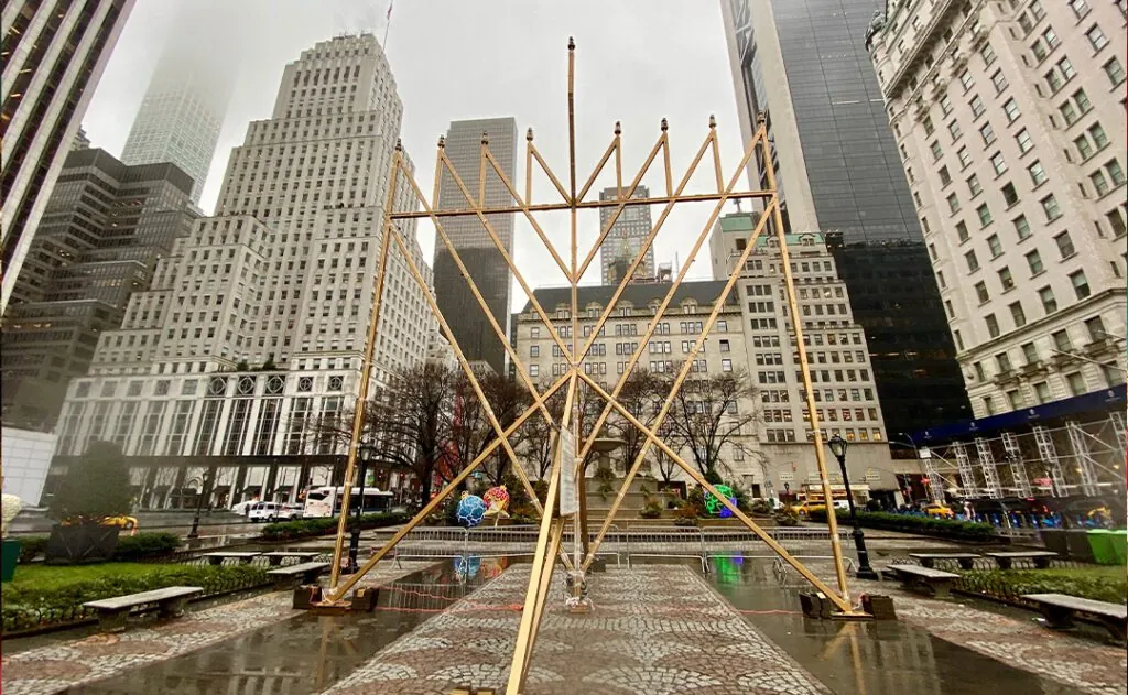 NEW YORK- DECEMBER 30, 2019: Manhattan Grand Army Plazas hosts World’s Largest Hanukkah Menorah. 32-foot-high, gold-colored, 4,000-pound steel holiday icon kicks off Jewish Festival of Lights
