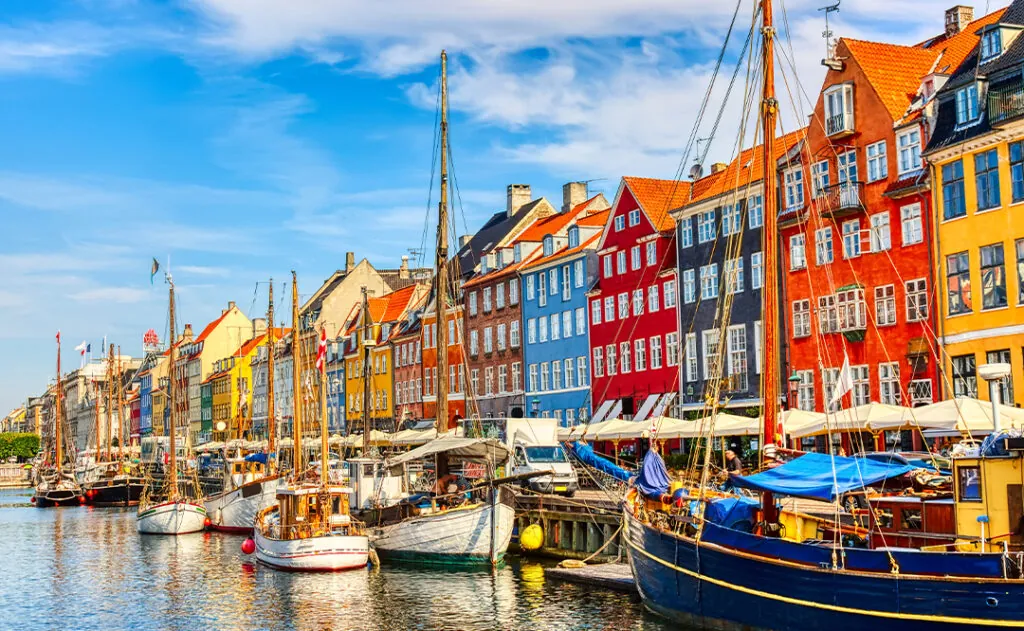 Copenhagen iconic view. Famous old Nyhavn port in the center of Copenhagen, Denmark during summer sunny day
